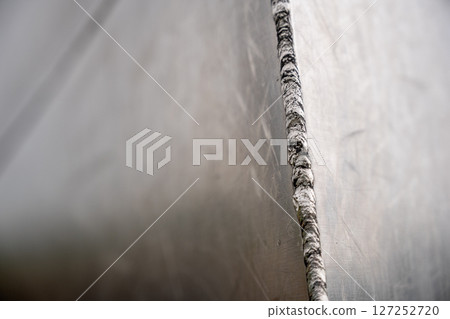 Selective focus on the weld bead and ground joint of stainless steal plats on the Gateway Arch National Park in St. Louis, Missouri Selective focus on the weld bead and ground joint of stainless steal plats on the Gateway Arch National Park in St. Louis, Missouri 127252720