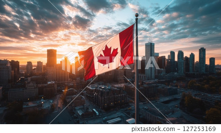Canadian flag waves proudly over skyline during sunset on independence day celebration 127253169