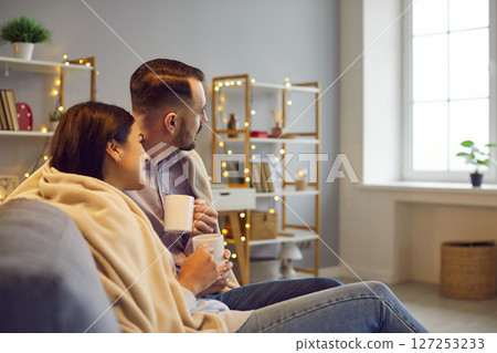 Married Couple Embracing On Sofa At Home Married Couple Embracing On Sofa At Home 127253233