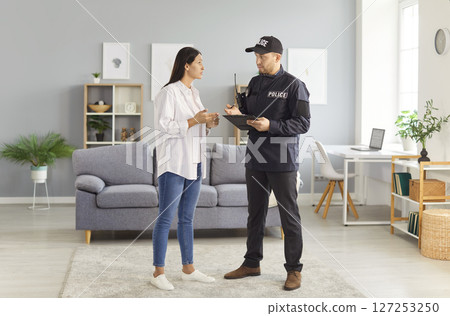 Victim And Police Officer Or Detective Talking During Crime Investigation Victim And Police Officer Or Detective Talking During Crime Investigation 127253250
