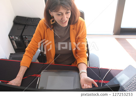 an adult woman in the office talking on phone call an adult woman in the office talking on phone call 127253253