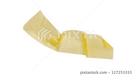 Yellow painter's tape isolated on white background, macro. Torn, crumpled, twisted strips of yellow painter's tape on white background 127253333