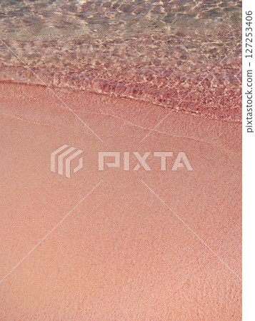 Pink sand and sea wave. Beach with pink sand in Elafonisi, Krit, Greece Pink sand and sea wave. Beach with pink sand in Elafonisi, Krit, Greece 127253406