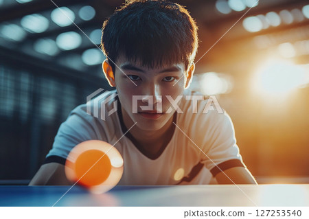 Blurred image of an Asian guy playing table tennis. Generated by artificial intelligence 127253540