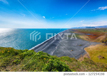 Impressive View of Kirkjufjara black sand beach from Dyrholaey promontory on Atlantic South Coast 127254198