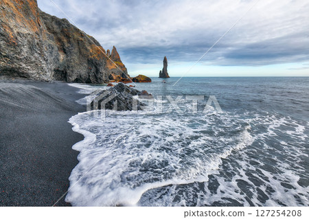 Impressive landscape with basalt rock formations Troll Toes on Black beach Reynisfjara near the village of Vik. Impressive landscape with basalt rock formations Troll Toes on Black beach Reynisfjara near the village of Vik. 127254208