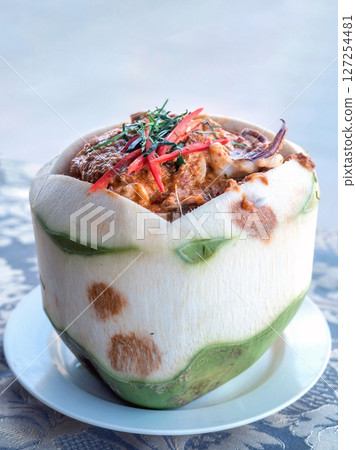 Close up of Steamed curry seafood in young coconut,selective focus 127254481
