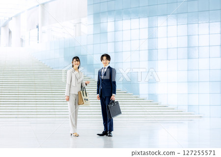 Business people standing in an office lobby 127255571