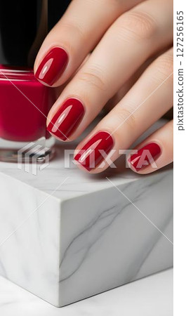 Womans hand with red nail polish 127256165