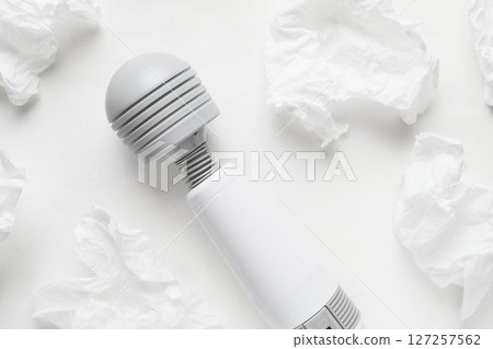 Massager and tissues on the sheets Massager and tissues on the sheets 127257562