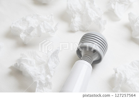 Massager and tissues on the sheets Massager and tissues on the sheets 127257564