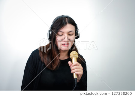 Woman (LGBTQ) singer sing a song with microphone 127258260