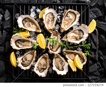 AI generated top view of fresh oysters grilled over charcoal, some shells open revealing plump juicy meat inside. Perfectly cooked with smoky aroma, seasoned with salt and black pepper, garnished. AI generated top view of fresh oysters grilled over charcoal, some shells open revealing plump juicy meat inside. Perfectly cooked with smoky aroma, seasoned with salt and black pepper, garnished. 127259274