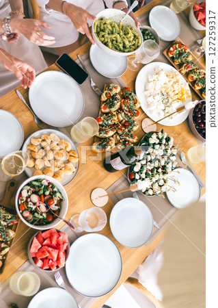 Top view of festive summer table with bruschetta, pasta, salad, cheese and watermelon, ready to eat 127259317