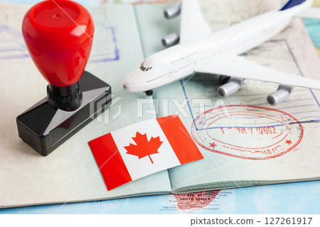 Canada flag and passport with airplane for travel. 127261917