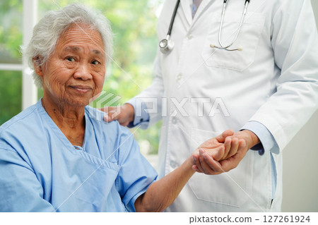Doctor taking care, help and encourage Asian elder senior woman patient in clinic hospital. Doctor taking care, help and encourage Asian elder senior woman patient in clinic hospital. 127261924