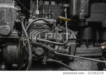 Background surface of old, black and oily machine engine Background surface of old, black and oily machine engine 127262219