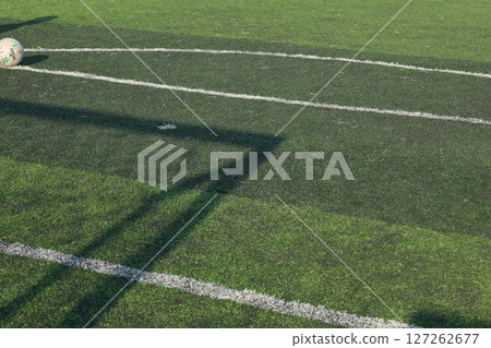 artificial green grass turf sport soccer field with black rubber granules infill and shadow artificial green grass turf sport soccer field with black rubber granules infill and shadow 127262677