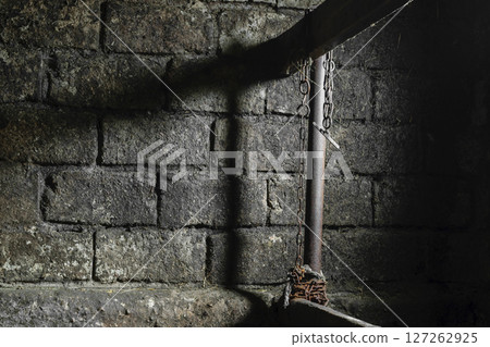 Dirty, Dark, Spooky, Scary and Mystic Farm Room for the Cows with Visible Hanging Rusty Chain on Partition Dirty, Dark, Spooky, Scary and Mystic Farm Room for the Cows with Visible Hanging Rusty Chain on Partition 127262925