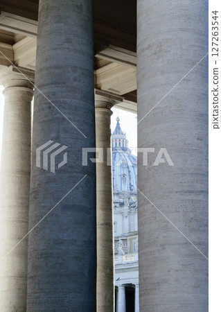 The St. Peters basilica visible through pillars in Vatican 127263544