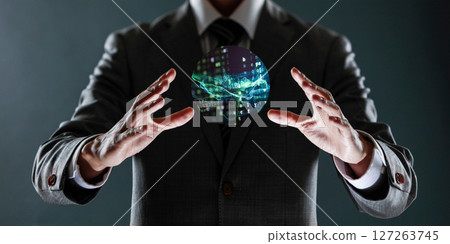businessman holding a sphere with a globe in his hands. 127263745