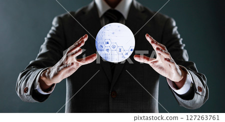 businessman holding a sphere with a globe in his hands. 127263761