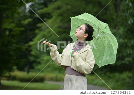 Smiling Japanese woman holding an umbrella 127264351