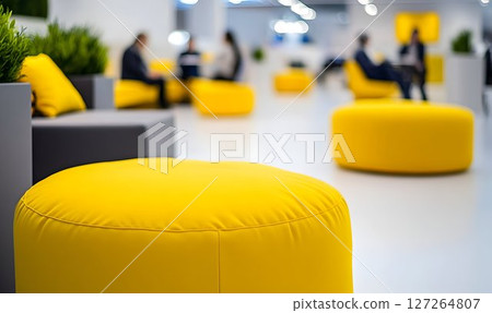 Vibrant Yellow Poufs Adorn a Modern Open Office Space Promoting Collaboration 127264807