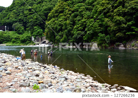 Angler fishing in the mud 127266236