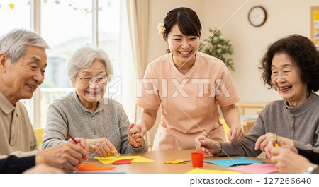Caregivers supporting elderly people in nursing homes 127266640