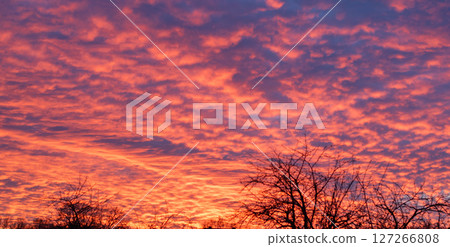 Vivid Sunset with Fiery Clouds Over Rural Landscape Vivid Sunset with Fiery Clouds Over Rural Landscape 127266808