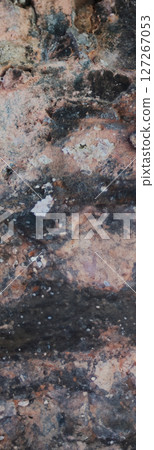 Dark vertical shot of eroded rock texture backdrop. Dark vertical shot of eroded rock texture backdrop. 127267053