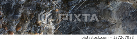 Close-up of dark volcanic stone with uneven surface.Wide view Close-up of dark volcanic stone with uneven surface.Wide view 127267058