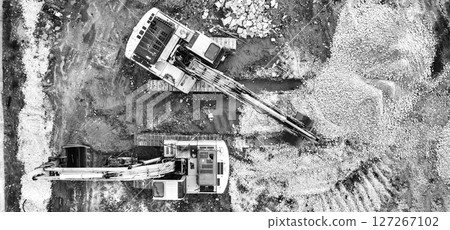 stopped excavators at a construction site 127267102