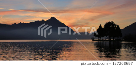 Lake Thunersee and Niesen at sunset. View from Neuhaus, Switzerland. Lake Thunersee and Niesen at sunset. View from Neuhaus, Switzerland. 127268697