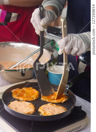 Cooking kimchi pancakes on a hot pan 127269654
