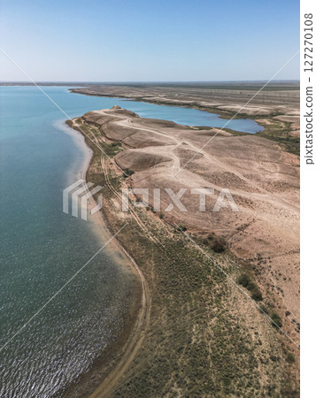 Kuimazar Reservoir shoreline landscape in Uzbekistan with blue water Kuimazar Reservoir shoreline landscape in Uzbekistan with blue water 127270108