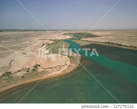 Aerial view of winding river, green vegetation and dry plains, Kuimazar region Aerial view of winding river, green vegetation and dry plains, Kuimazar region 127270126