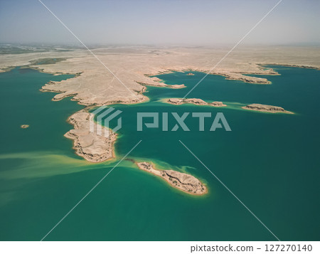 Aerial view of blue Kuimazar Reservoir and sandy islands in arid Uzbek landscape Aerial view of blue Kuimazar Reservoir and sandy islands in arid Uzbek landscape 127270140