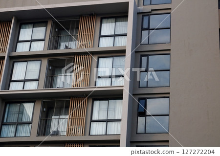 Balcony of building with glass and curtain decorated room. 127272204