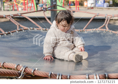 [相模原市麻溝公園兒童遊樂場，一歲兒童在彈跳床上玩耍] 127273215
