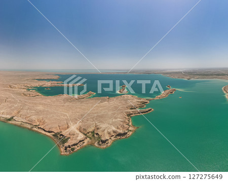 Turquoise bays, arid terrain and islands of Kuimazar Reservoir Uzbekistan summer 127275649