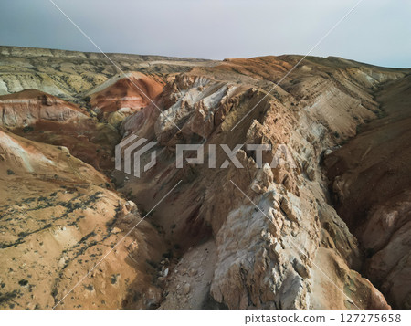 Aerial view of stratified slopes and ridges in Aktumsuk, Uzbekistan 127275658