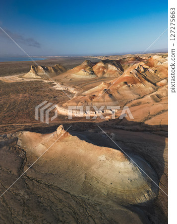 Aerial view over Aktumsik Cape's peaks near the vanished Aral Sea shoreline Aerial view over Aktumsik Cape's peaks near the vanished Aral Sea shoreline 127275663