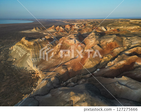 Majestic erosion lines of Aktumsuk cape in Karakalpakstan during golden hour Majestic erosion lines of Aktumsuk cape in Karakalpakstan during golden hour 127275666