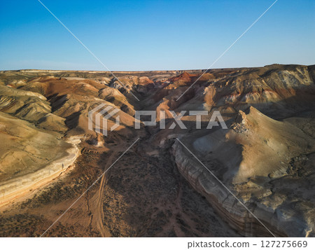 Aerial view across Aktumsik Cape, revealing vast colored hills, ancient valleys 127275669