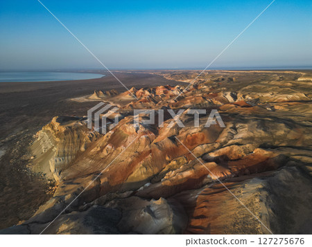 Aerial view over colored cliffs of Aktumsuk cape, ancient Aral Sea shoreline 127275676