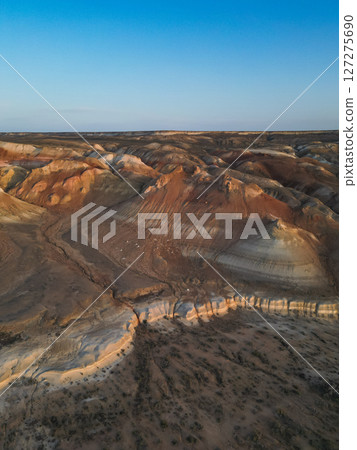 Sunrise paints multicolored hills and ravines of Aktumsik headland in Uzbekistan Sunrise paints multicolored hills and ravines of Aktumsik headland in Uzbekistan 127275690