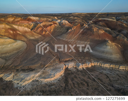 Aerial view over Aktumsik's colorful sediment hills and deep desert ravines Aerial view over Aktumsik's colorful sediment hills and deep desert ravines 127275699