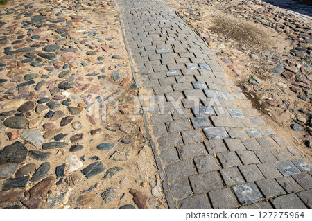 Two types of paving stones and cobblestones on a city road Two types of paving stones and cobblestones on a city road 127275964
